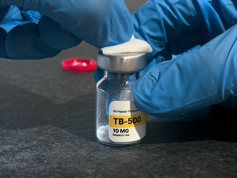 Wiping the vial top with alcohol